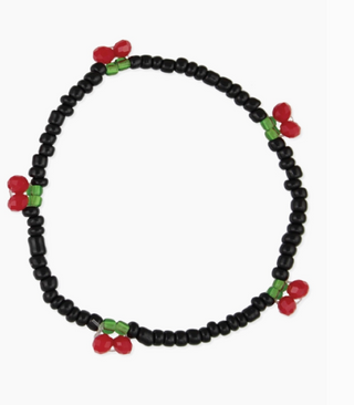 The Cherry Beaded Stretch Bracelet by Zad features small black beads with red and green beaded clusters styled as cherries, evenly spaced around the stretch band.