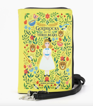 The Comeco Inc Goldilocks And The Three Bears Book Clutch Bag is a yellow purse with an illustrated cover of Goldilocks, three bear faces, colorful flowers and leaves, and a black strap.