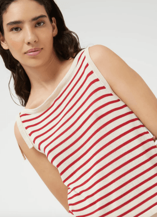 A woman with long dark hair models the Compania Fantastica Nautical Stripe Knit Tank Top-FINAL SALE in off-white with red stripes, facing slightly sideways and looking at the camera against a plain light background.