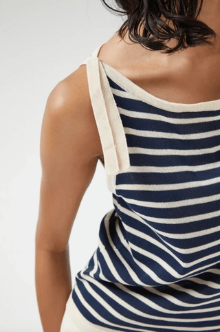 A person models the Compania Fantastica Nautical Stripe Knit Tank Top-FINAL SALE, featuring navy and white stripes, cream trim, and a classic boat neckline for timeless style. Shown from shoulder to mid-torso.